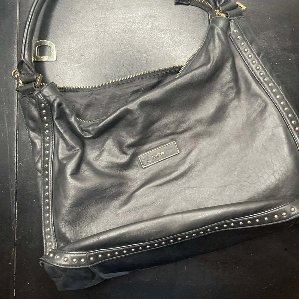 DKNY black leather shoulder bag with stud detailing.